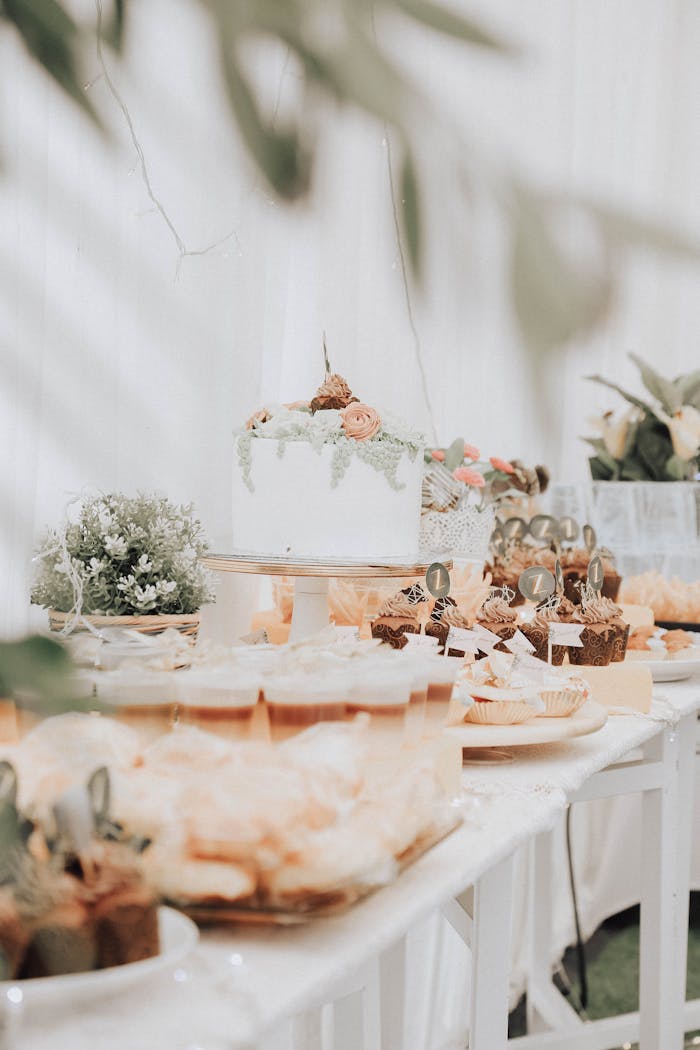 Beautifully arranged dessert table with cakes and cupcakes at a wedding reception.